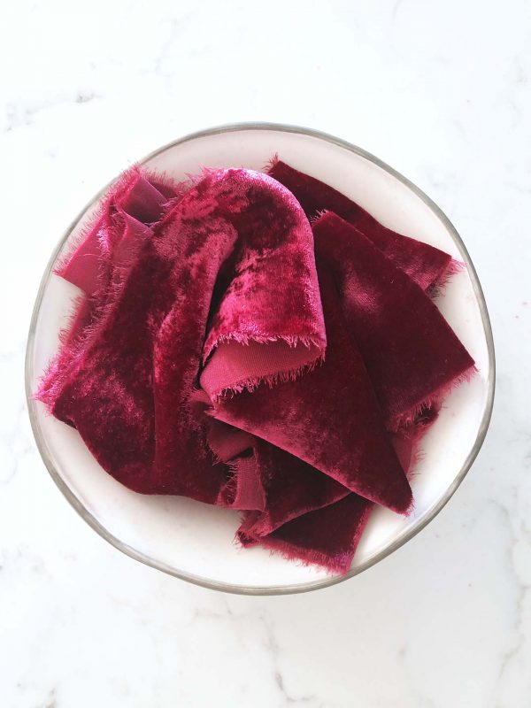 Handcrafted velvet ribbon in Cranberry with frayed edges