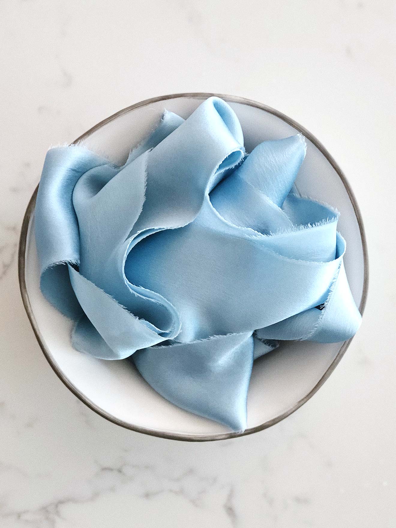 Handcrafted silk ribbon in Glacier blue with frayed edges