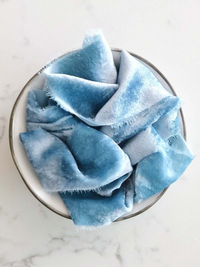 Handcrafted velvet ribbon in Glacier blue with frayed edges
