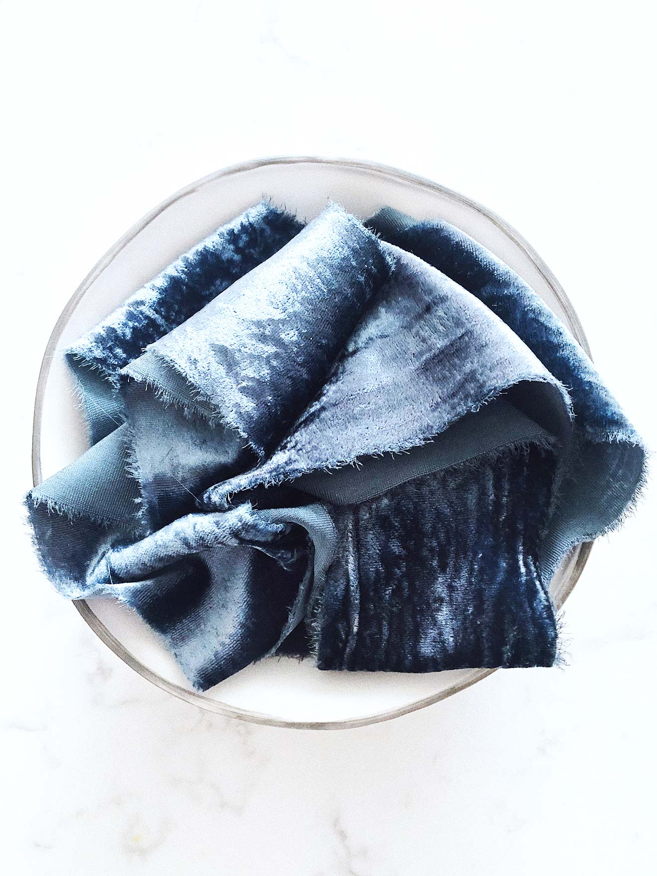 Handcrafted velvet ribbon in Deep Waters blue with frayed edges